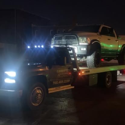 Laurie&rsquo;s flatbed transporting a vehicle at night